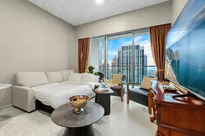 a hotel room with a bed and a piano at FIRST CLASS 1BR Stylish & Luxurious in Dubai