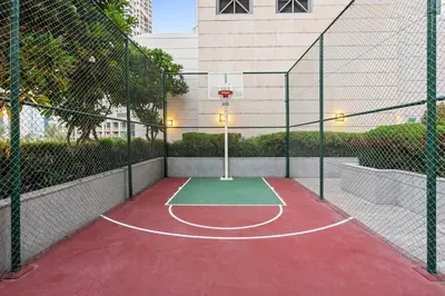 a basketball court with a net and a basketball hoop at Walk to Dubai Mall 2BR Apartment with Balcony and Pool in Dubai
