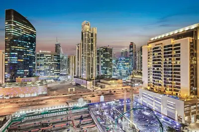 a view of a city at night with buildings at Walk to Dubai Mall 2BR Apartment with Balcony and Pool in Dubai