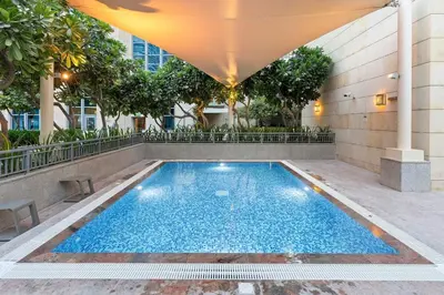 a swimming pool in the middle of a building at Walk to Dubai Mall 2BR Apartment with Balcony and Pool in Dubai