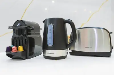 a group of appliances sitting on a counter at Walk to Dubai Mall 2BR Apartment with Balcony and Pool in Dubai