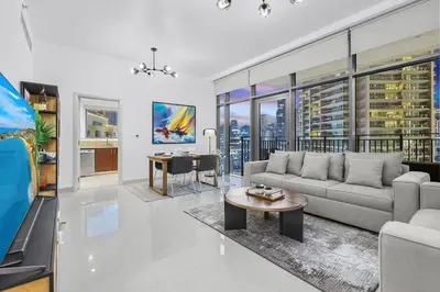 a living room with a couch and a table at FIRST CLASS 1BR Panoramic City View in Dubai