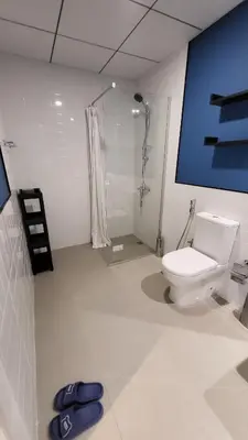 a bathroom with a toilet and a shower at Modern 2BR -5MIN to Metro & Festival Mall- 1211 in Dubai