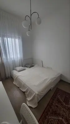a white bed in a room with a chandelier at Modern 2BR -5MIN to Metro & Festival Mall- 1211 in Dubai