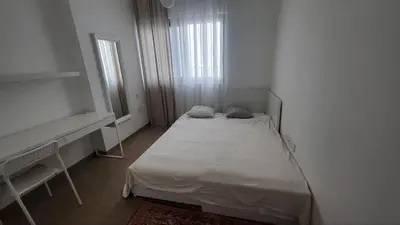 a small white room with a bed and a window at Modern 2BR -5MIN to Metro & Festival Mall- 1211 in Dubai