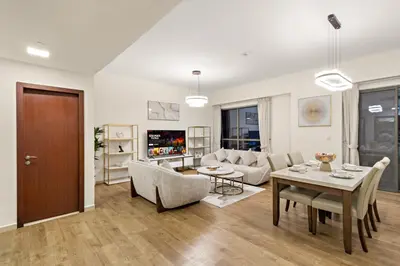 a living room with a table and a couch at Luxe 2BR with Marina View in JBR and Walk to the Beach in Dubai