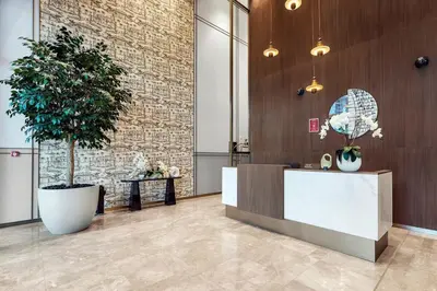 a lobby with a reception desk and a plant at FIRST CLASS 2BR Incredible Burj Khalifa View in Dubai