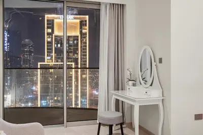 a bathroom with a sink and a mirror and a window at FIRST CLASS 2BR Incredible Burj Khalifa View in Dubai