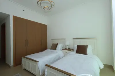 two beds sitting next to each other in a bedroom at Lux 2 Bed in Downtown Dubai w Dubai Mall Access in Dubai