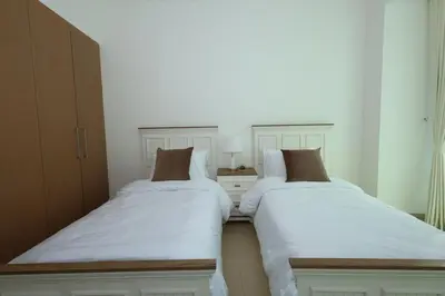 two beds sitting next to each other in a bedroom at Lux 2 Bed in Downtown Dubai w Dubai Mall Access in Dubai