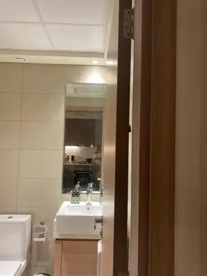 a bathroom with a sink and a toilet and a mirror at furnished one bedroom huge terrace in Dubai