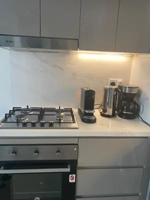 a kitchen counter with a stove and appliances on it at furnished one bedroom huge terrace in Dubai
