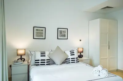 a bedroom with a large white bed with pillows at Luxury Escapes - Modern 3BR Apt Stylish, Spacious and Comfortable in Dubai