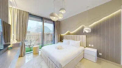 a bedroom with a white bed and a large window at Boulevard Point - One Bed with Burj Khalifa View in Dubai