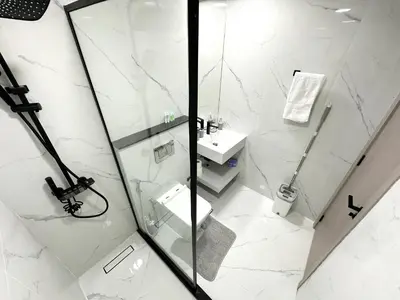 a bathroom with a shower and a toilet and a sink at Dubai Marina - 1BHK Fancy Apartment in Dubai