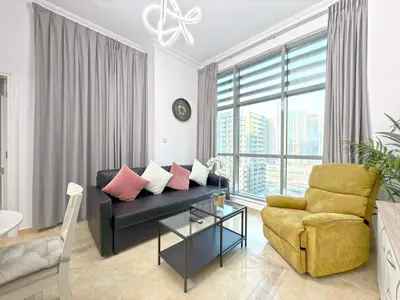 a living room with a couch and a chair at One BedRoom near Beach and Metro in Dubai Marina Z1011 in Dubai