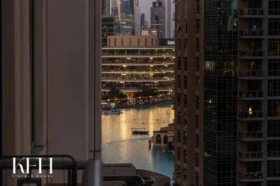 a view of a river between two tall buildings at Kinfolk Homes - No 1 Family Stay, Partial Burj Khalifa Fountain View in Dubai