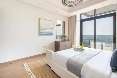 a bedroom with a large bed and a large window at Frank Porter - Nobles Tower in Dubai