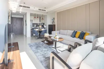 a living room with a couch and a table at Frank Porter - Nobles Tower in Dubai