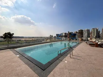 a large swimming pool on top of a building at Frank Porter - Nobles Tower in Dubai