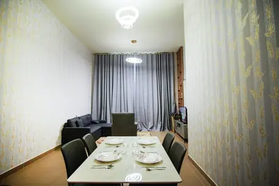 a dining room with a table and chairs and a couch at High Class 1bhk Business bay Marasi Drive Dubai in Dubai