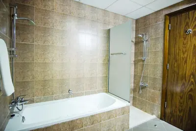 a bathroom with a bath tub and a shower at High Class 1bhk Business bay Marasi Drive Dubai in Dubai