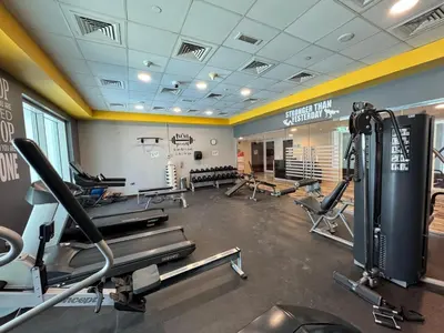a gym with treadmills and cardio equipment in a room at High Class 1bhk Business bay Marasi Drive Dubai in Dubai
