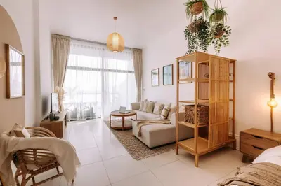 a living room with a couch and a chair at Beachfront Bliss on the Palm Jumeirah in Dubai