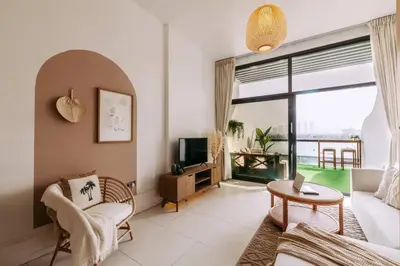 a living room with a couch and a tv at Beachfront Bliss on the Palm Jumeirah in Dubai