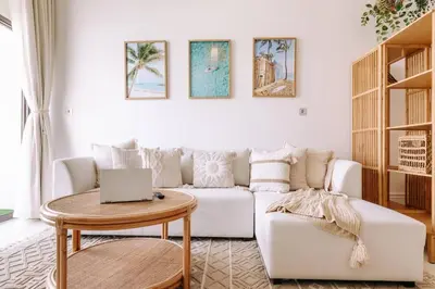 a living room with a white couch and a table at Beachfront Bliss on the Palm Jumeirah in Dubai