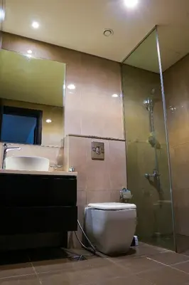 a bathroom with a toilet and a sink and a shower at Lala Land Homes - Magnificent 1 Br in Business Bay in Dubai