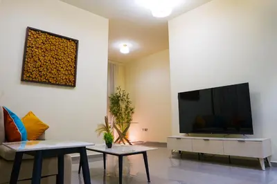 a living room with a flat screen tv on a wall at Lala Land Homes - Magnificent 1 Br in Business Bay in Dubai