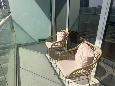 three wicker chairs sitting on top of a balcony at Damac Hills in Dubai