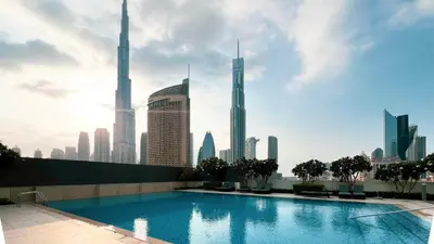 a swimming pool with a view of the dubai skyline at High-Floor Luxe 2BR Stunning Burj Khalifa & Fountain Views Direct Dubai Mall Access in Dubai