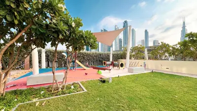 a playground in a park in a city at High-Floor Luxe 2BR Stunning Burj Khalifa & Fountain Views Direct Dubai Mall Access in Dubai