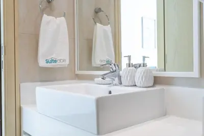 a bathroom with a white sink and a mirror at Premium 3-bedroom with Direct Beach Access in JBR in Dubai