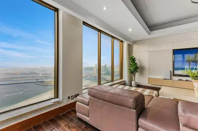 a living room with a couch and a large window at Luxury 6BR JBR Penthouse Panoramic Sea Views, Steps to Marina Beach & The Walk in Dubai