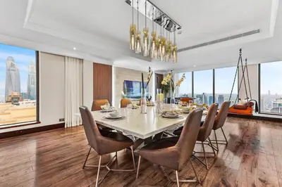 a dining room with a large table and chairs at Luxury 6BR JBR Penthouse Panoramic Sea Views, Steps to Marina Beach & The Walk in Dubai