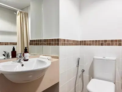 a bathroom with a sink and a toilet at 2 Bed Apartment in La Riviera Tower, Dubai Marina near Metro and Mall, 12-min walk to JBR Beach! in Dubai