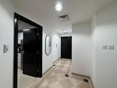 a hallway with a black door and a mirror at 2 Bed Apartment in La Riviera Tower, Dubai Marina near Metro and Mall, 12-min walk to JBR Beach! in Dubai