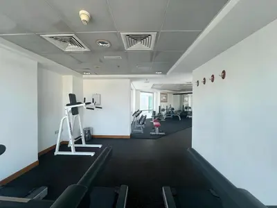a room with a gym with treadmills and machines at 2 Bed Apartment in La Riviera Tower, Dubai Marina near Metro and Mall, 12-min walk to JBR Beach! in Dubai