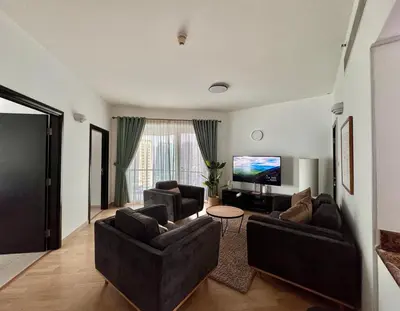 a living room with two couches and a flat screen tv at 2 Bed Apartment in La Riviera Tower, Dubai Marina near Metro and Mall, 12-min walk to JBR Beach! in Dubai