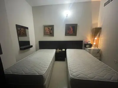 a room with two beds in a room at Room In Barsha Heights in Dubai