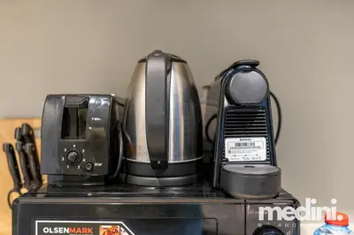 a microwave and a toaster sitting on top of a appliance at New Listing - Sauna - Gym Pool - Business Bay in Dubai