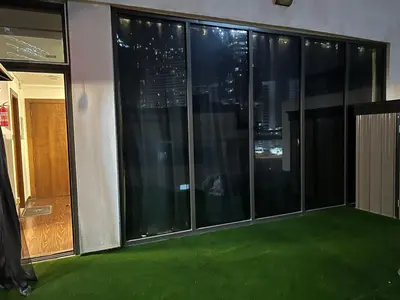 a balcony with green flooring in a building at Jumeirah Village Circle JVC One bedroom Luxurious Apartment in Dubai