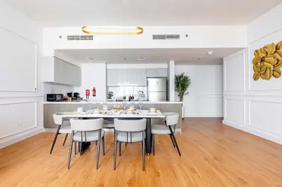 a kitchen and dining room with a table and chairs at Luxurious 4BR, Burj Khalifa & full fountain view, Downtown Dubai in Dubai
