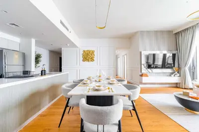 a kitchen and dining room with a table and chairs at Luxurious 4BR, Burj Khalifa & full fountain view, Downtown Dubai in Dubai