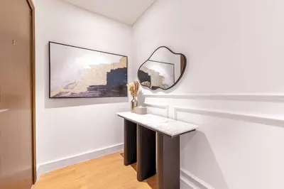 a white room with a mirror and a table at Luxurious 4BR, Burj Khalifa & full fountain view, Downtown Dubai in Dubai