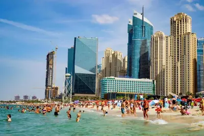 a group of people on a beach in the water at AHLAN Dubai Marina JBR in Dubai