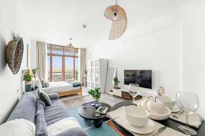 a living room with a couch and a tv at Silkhaus Sea View Studio in Palm Jumeirah in Dubai